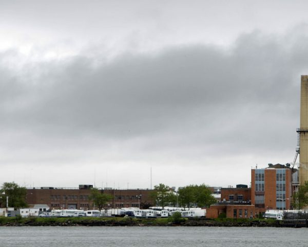 The various buildings that makeup the Rikers Island jail complex, shot from across the river.